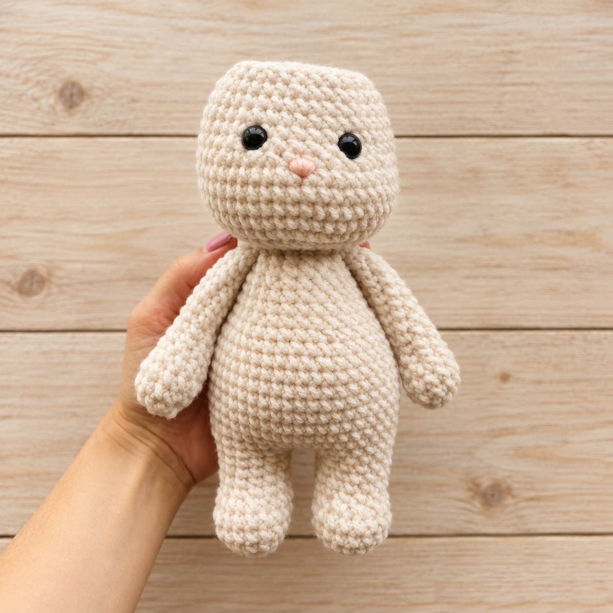 Unfinished amigurumi bunny body before adding long ears