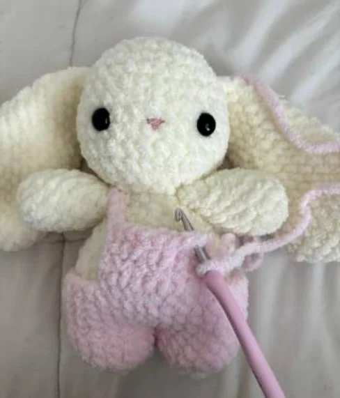 Original crochet process photo showing the baby bunny overalls