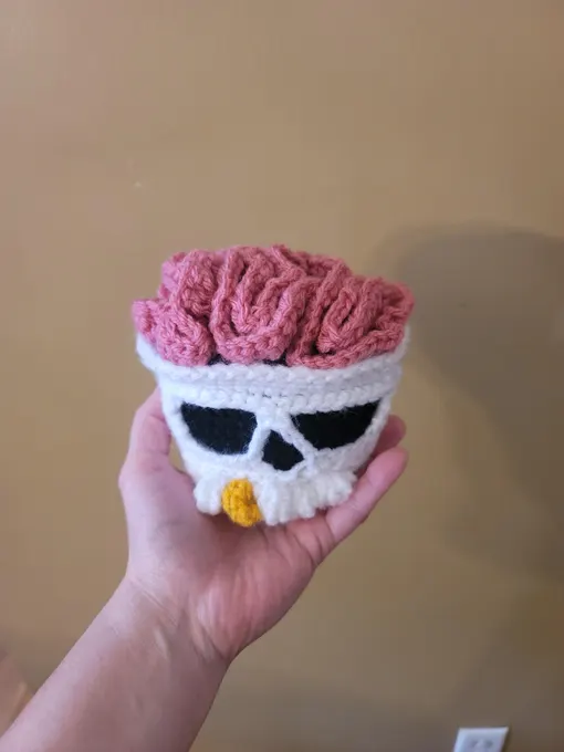 Customer holding a finished Brainy Skull crochet organizer