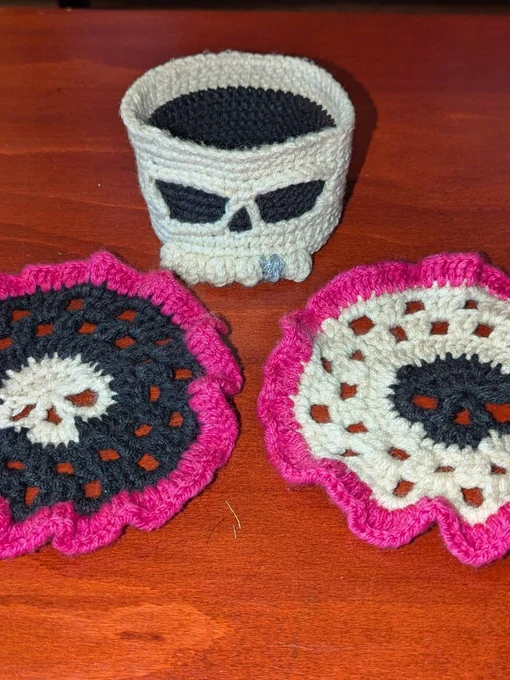 Customer-made crochet skull coasters with bright pink ruffles