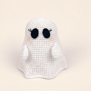 White crochet ghost cloak with black oval eyes, eyelashes, and small arms