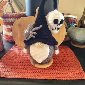 Halloween gnome crochet design with skull hat and spider