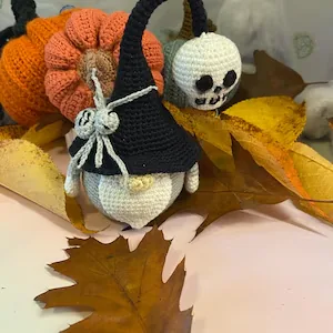 Crochet Halloween gnome styled with autumn leaves