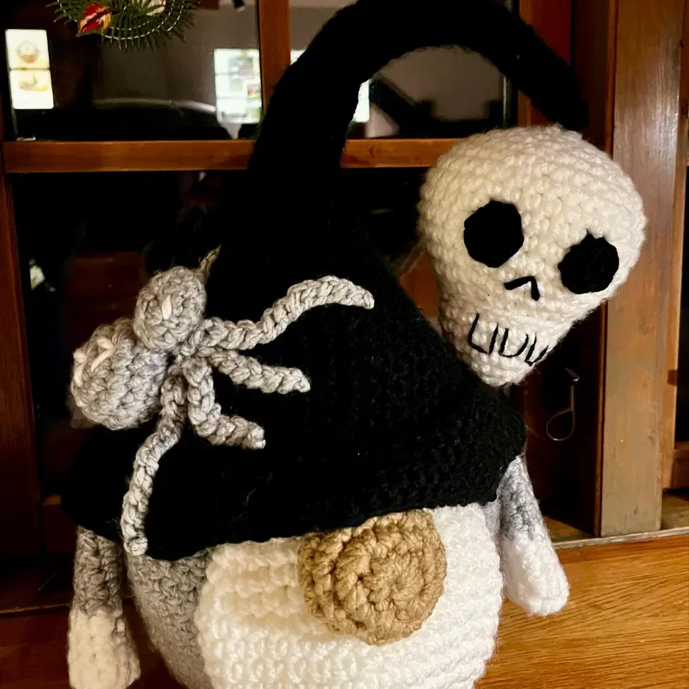 Halloween crochet gnome pattern with skull and spider close up