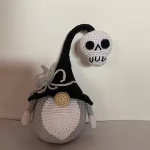 Neutral Halloween crochet gnome with black curved hat skull and spider